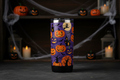Halloween themed tumbler with jack-o-lanterns bats and witches in orange black and purple
