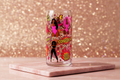 Hot girls glass tumbler with bold empowerment artwork in hot pink red and gold on pink marble surface
