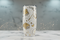White wizard tumbler with gold and silver mystical artwork on white marble surface